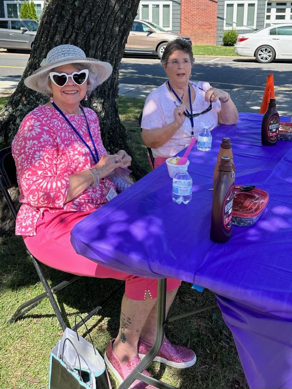 Linda Crowe and Bonnie Ekas hand out ice cream toppings.